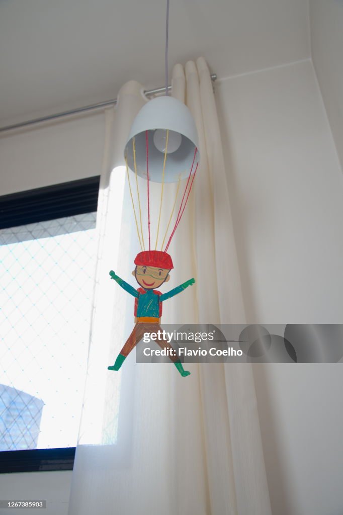 Handmade paratrooper toy hanging from lamp