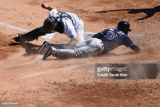 Manuel Margot of the Tampa Bay Rays slides safely into home plate ahead of the tag by Erik Kratz of the New York Yankees during the fifth inning at...