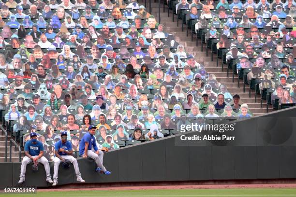 Julio Urias, Dennis Santana and Victor Gonzalez of the Los Angeles Dodgers look on before their game against the Seattle Mariners at T-Mobile Park on...
