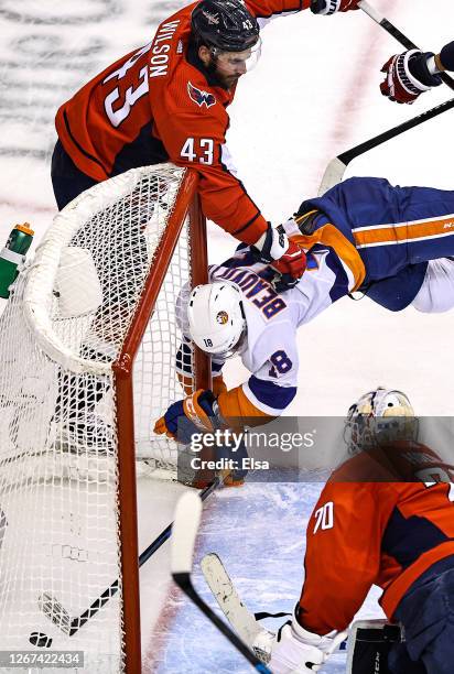 Anthony Beauvillier of the New York Islanders is checked into the goal post by Tom Wilson of the Washington Capitals after scoring his second goal of...