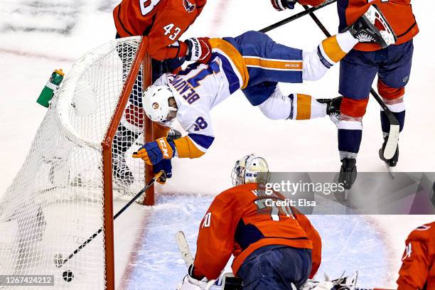 Anthony Beauvillier of the New York Islanders scores his second goal of the game past Braden Holtby of the Washington Capitals as he is checked into...