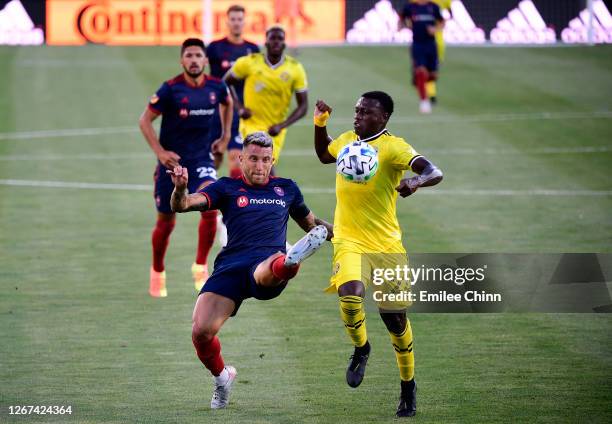 Francisco Calvo of Chicago Fire defends the ball from Derrick Etienne of Columbus Crew in the first half during their game at MAPFRE Stadium on...