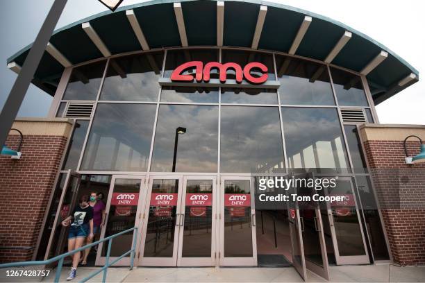 Movie goers leave the AMC Highlands Ranch 24 on August 20, 2020 in Highlands Ranch, Colorado. AMC Theatres reopened more than 100 of its movie...