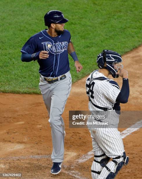 Jose Martinez of the Tampa Bay Rays in action against Gary Sanchez of the New York Yankees at Yankee Stadium on August 19, 2020 in New York City. The...