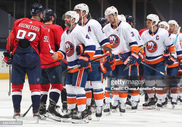 Andy Greene of the New York Islanders and Evgeny Kuznetsov of the Washington Capitals and their teammates shake hands after the Islanders' 4-0 win in...