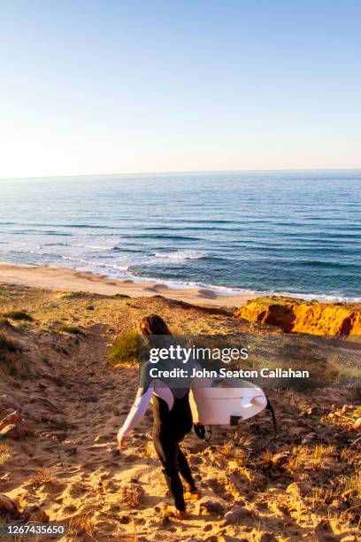 tunisia, surfer walking to a beach of the mediterranean sea - tunisia surfing one person stock pictures, royalty-free photos & images