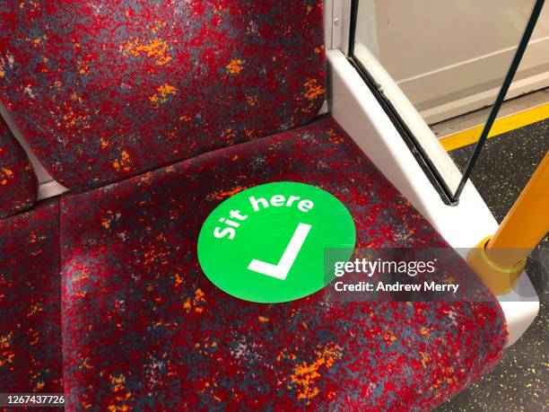 social distancing checkmark sign on empty train seat, covid-19 pandemic - underground train stock pictures, royalty-free photos & images