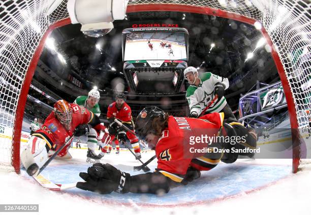 Radek Faksa of the Dallas Stars scores a power play goal on goaltender Cam Talbot of the Calgary Flames as Rasmus Andersson reaches to stop the puck...