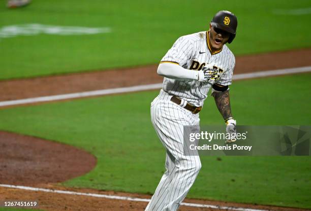 Manny Machado of the San Diego Padres reacts after hitting a walk-off grand slam during the 10th inning of a baseball game against the Texas Rangers...