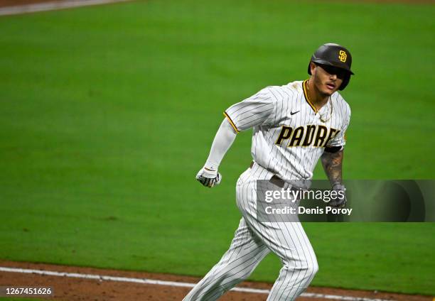 Manny Machado of the San Diego Padres reacts after hitting a walk-off grand slam during the 10th inning of a baseball game against the Texas Rangers...