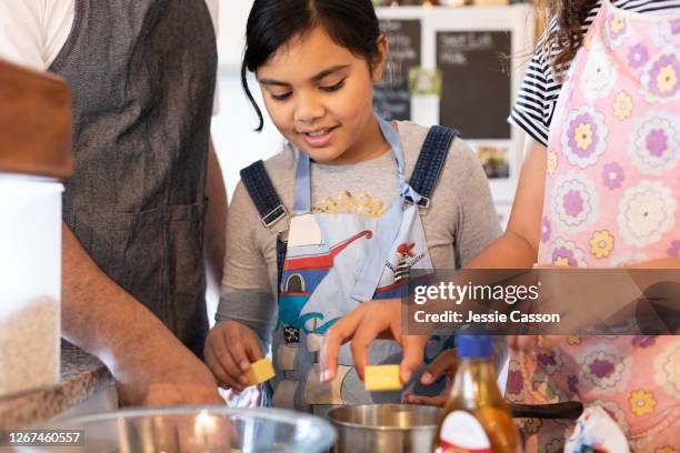 two children and dad cooking in the kitchen - auckland food stock pictures, royalty-free photos & images