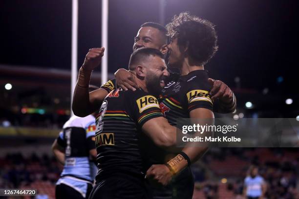 Josh Mansour of the Panthers celebrates after scoring a try with Jarome Luai and the team during the round 15 NRL match between the Penrith Panthers...