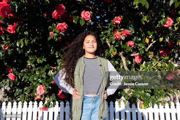 portrait of a girl against a flowering tree - teen courage stock pictures, royalty-free photos & images