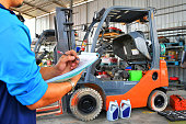The mechanic is checking the quality and Maintenance Forklift
