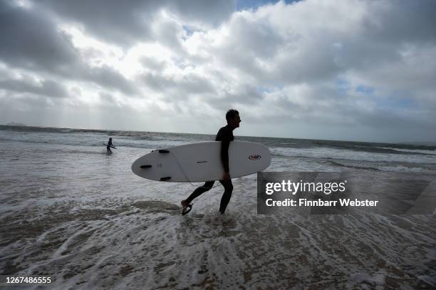 Surfers enjoy the waves at Branksome beach on August 21, 2020 in Bournemouth, United Kingdom. The Met Office extended a weather warning for strong...