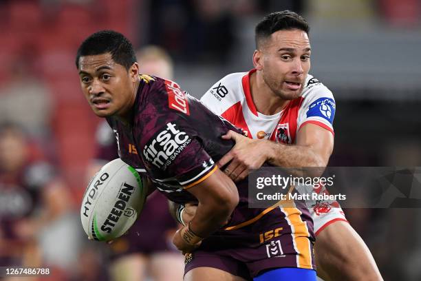 Anthony Milford of the Broncos is tackled by Corey Norman of the Dragons during the round 15 NRL match between the Brisbane Broncos and the St George...