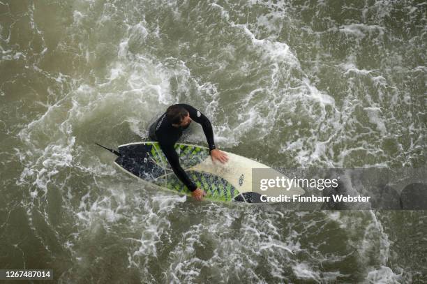 Surfers enjoy the waves at the beach on August 21, 2020 in Bournemouth, United Kingdom. The Met Office extended a weather warning for strong winds a...