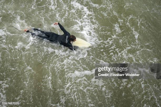 Surfers enjoy the waves at the beach on August 21, 2020 in Bournemouth, United Kingdom. The Met Office extended a weather warning for a further...