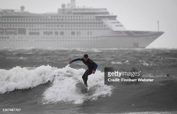Surfers enjoy the waves at the beach on August 21, 2020 in Bournemouth, United Kingdom. The Met Office extended a weather warning for strong winds a...