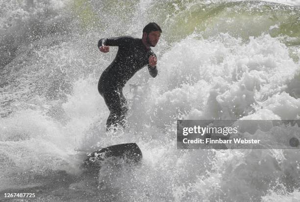 Surfers enjoy the waves at the beach on August 21, 2020 in Bournemouth, United Kingdom. The Met Office extended a weather warning for strong winds a...