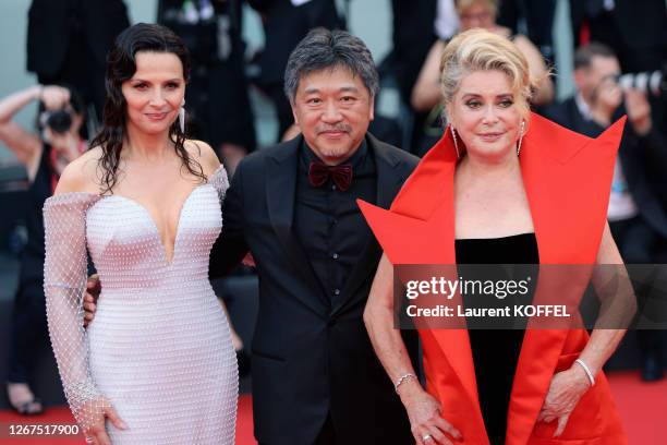 Juliette Binoche, Hirokazu Koreeda and Catherine Deneuve walk the red carpet ahead of the Opening Ceremony and the "La Vérité" screening during the...