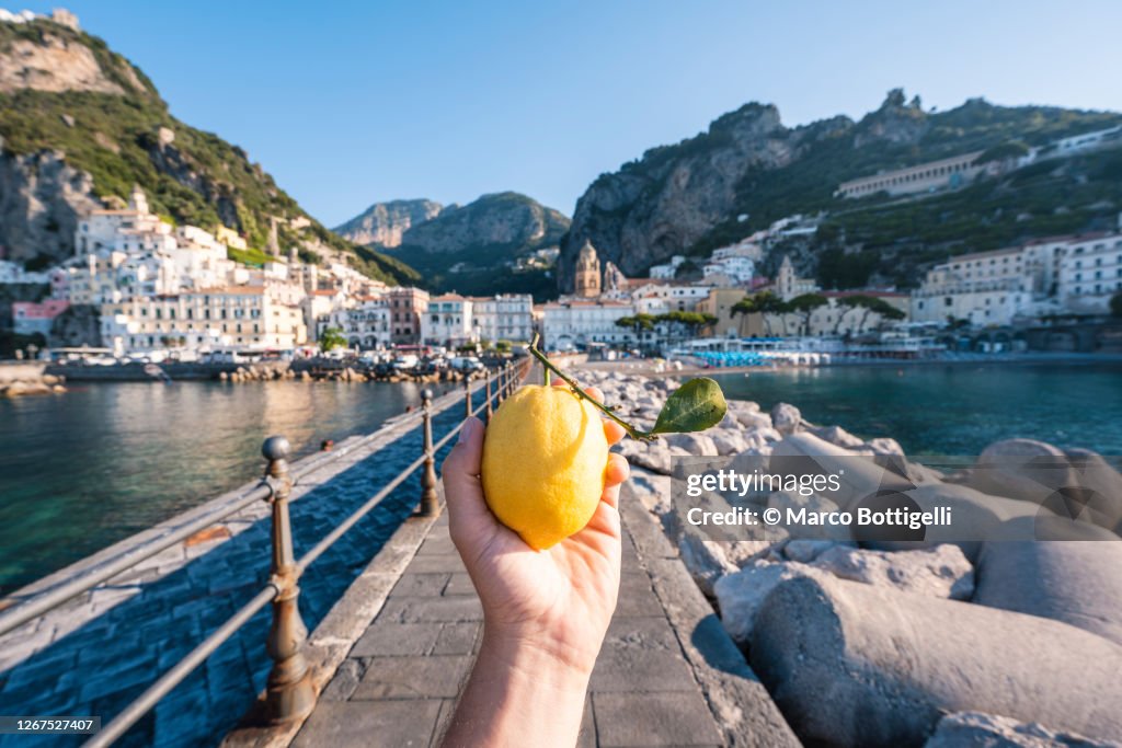 Personal perspective of person holding a lemon fruit in Amalfi, Italy