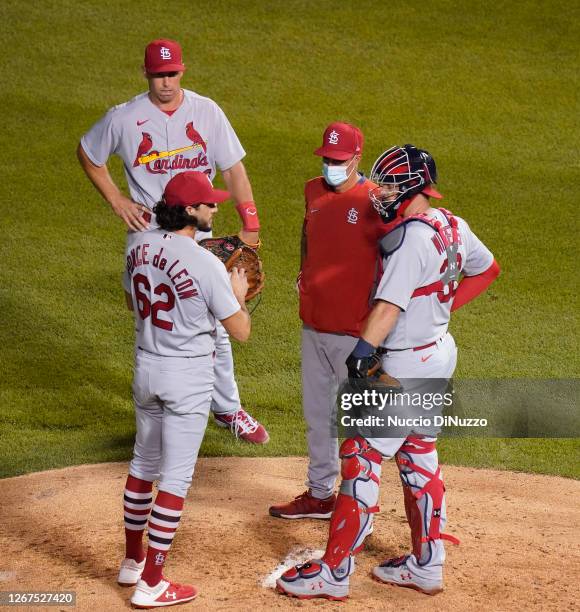 Pitching coach Mike Maddux of the St. Louis Cardinals visits the mound to speak with Daniel Ponce de Leon and Matt Wieters during the third inning of...