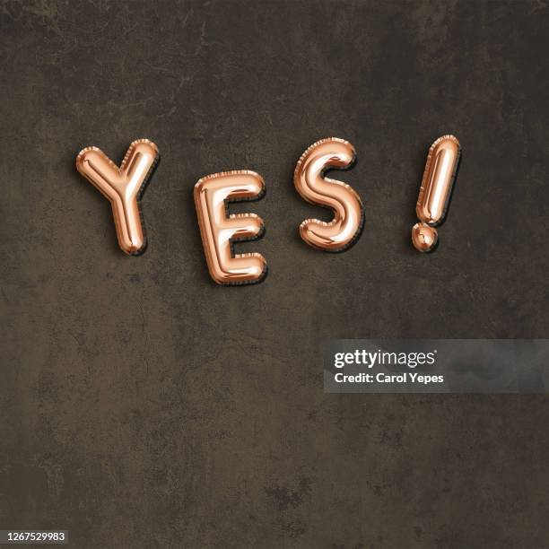 yes single word in golden foiled balloon and black background - english language bildbanksfoton och bilder