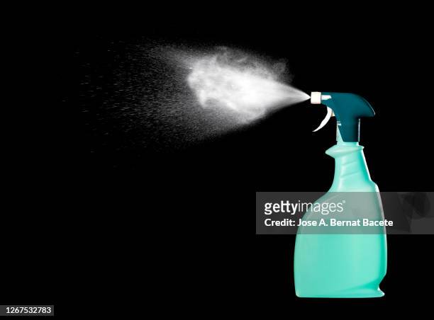 close-up of spray bottle with cleaning or disinfectant fluid on a black background. - botella para rociar fotografías e imágenes de stock