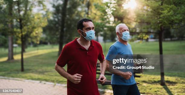 father and son outdoors workout - jogging mask stock pictures, royalty-free photos & images