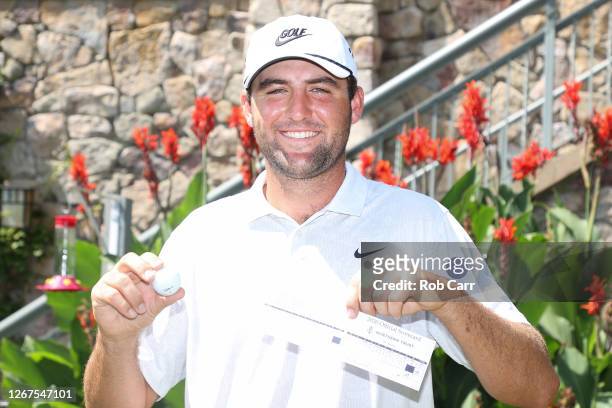 Scottie Scheffler of the United States holds up his ball and score card in celebration after scoring a 59 during the second round of The Northern...