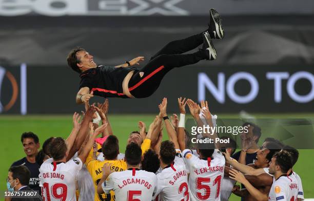 Julen Lopetegui, Head Coach of Sevilla is thrown into the air in celebration by his players following their team's victory in the UEFA Europa League...