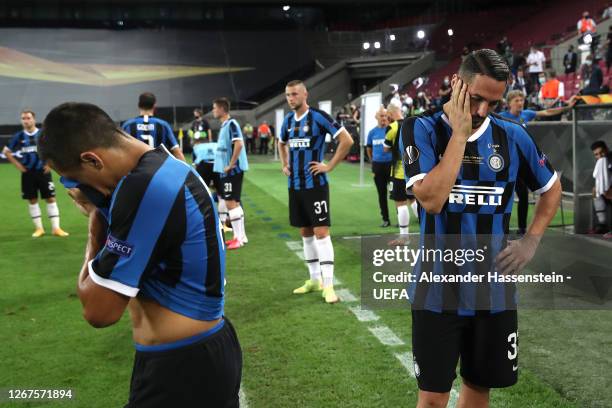 Alexis Sanchez and Danilo D'Ambrosio of Inter Milan look dejected following their team's defeat during the UEFA Europa League Final between Seville...