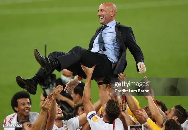 Ramon Rodriguez Verdejo, Director of Football of Seville celebrates with players following the UEFA Europa League Final between Seville and FC...