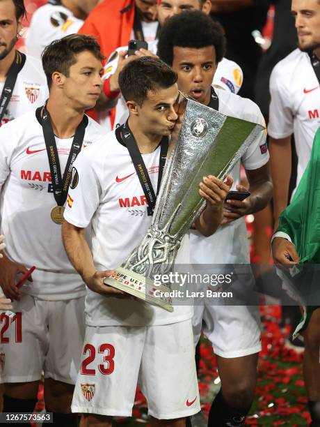 Sergio Reguilon of Sevilla kisses the UEFA Europa League Trophy following his team's victory in the UEFA Europa League Final between Seville and FC...