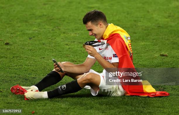 Sergio Reguilon of Sevilla celebrates with his winners medal on facetime following his team's victory in the UEFA Europa League Final between Seville...