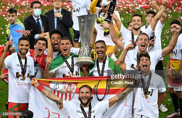 Players of Sevilla FC celebrate with the UEFA Europa League Trophy following victory in the UEFA Europa League Final between Seville and FC...