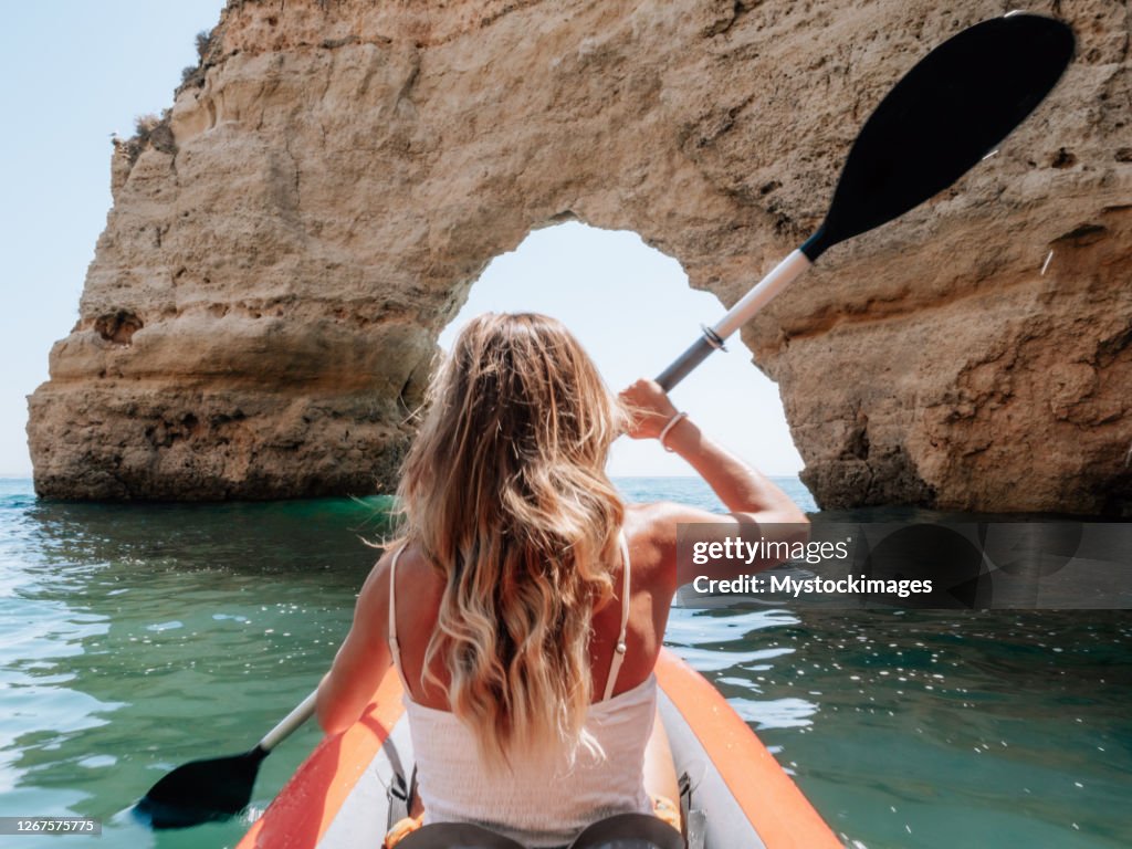 Rear view of woman on canoe