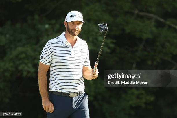 Dustin Johnson of the United States reacts after putting on the 18th hole to finish the day with a 60 during the second round of The Northern Trust...