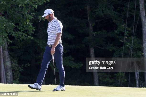 Dustin Johnson of the United States reacts after missing a putt on the 18th green during the second round of The Northern Trust at TPC Boston on...