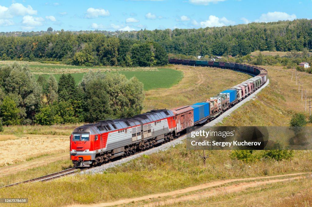 Modern diesel engine hauling a heavy freight train in beautiful countryside