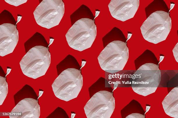 white plastic bag on the red background - plastic bag stock pictures, royalty-free photos & images