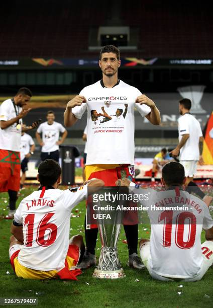 Jesus Navas, Sergio Escudero, and Ever Banega of Sevilla celebrate with the UEFA Europa League Trophy following their team's victory in during the...