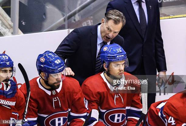 Interim head coach Kirk Muller of the Montreal Canadiens speaks with Jake Evans against the Philadelphia Flyers during the first period in Game Six...