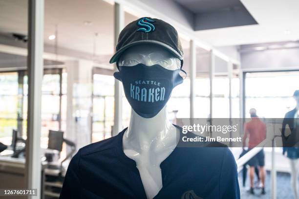 Mannequin highlights a face mask and hat advertising the NHL's newest franchise during the grand opening of Seattle Kraken Team Store on August 21,...