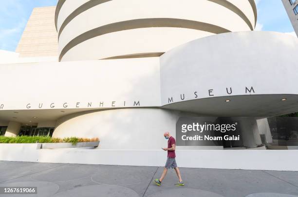 Person wears a protective face mask outside Solomon R. Guggenheim Museum as the city continues Phase 4 of re-opening following restrictions imposed...