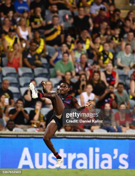 Irving Mosquito of the Bombers kicks his first goal on debut during the round 13 AFL match between the Essendon Bombers and the Richmond Tigers at...