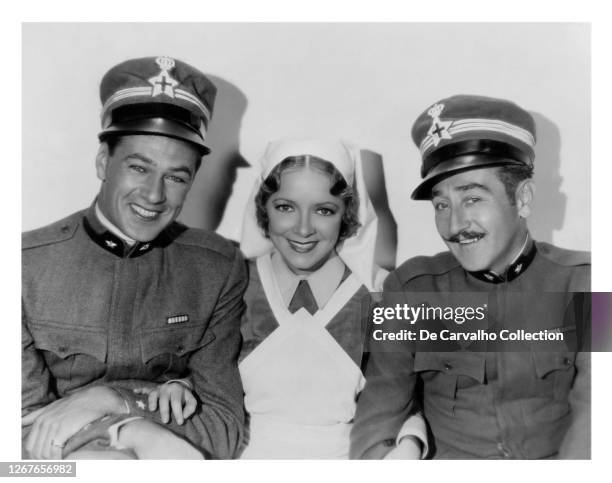 Actor Gary Cooper as 'Frederic’' Actress Helen Hayes as 'Catherine' and Actor Adolphe Menjou as 'Rinaldi' in a publicity shot from the movie 'A...