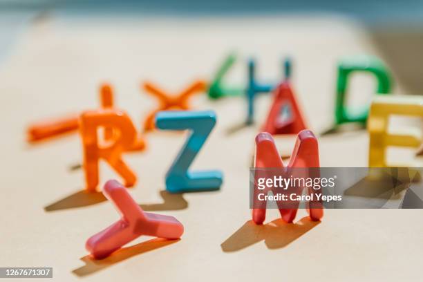 messy capital plastic letters with shadows.focus on m - ortografia fotografías e imágenes de stock