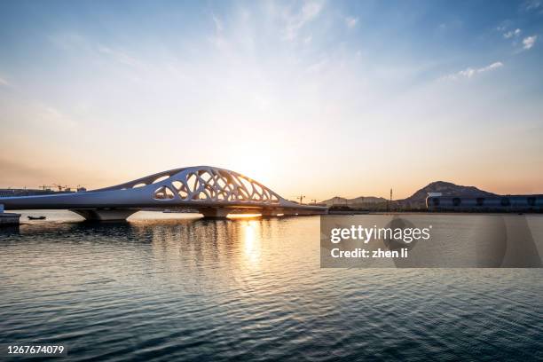 modern bridge structure at sunset - qingdao stock pictures, royalty-free photos & images